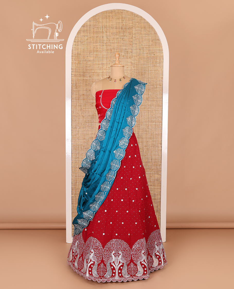 Tomato red half-saree, buttas, tree, and peacock motifs embroidered semi-taffeta silk top, matching blouse, and contrast scallop embroidered dhavani