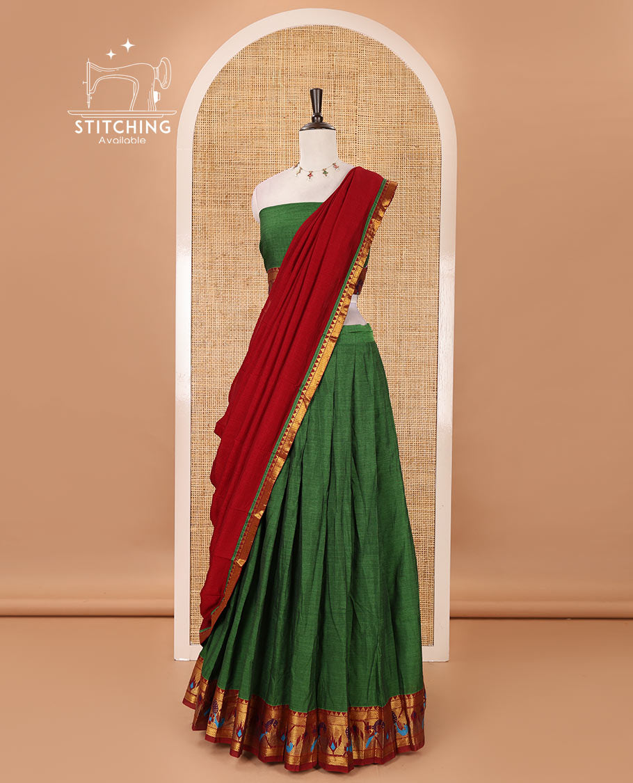 Green mercerised cotton half-saree, plain & contrast paithani peacock border skirt, matching blouse & contrast plain zari border dhavani