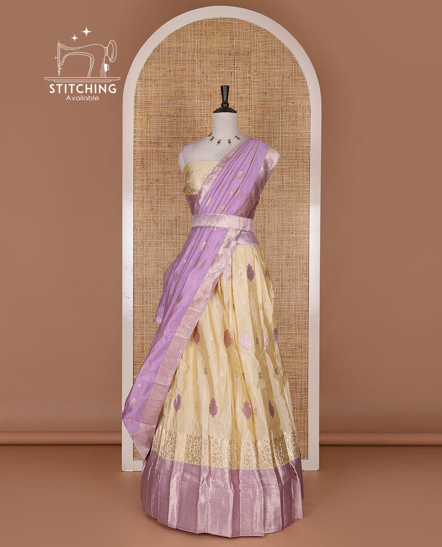 Cream taffeta silk half saree, meena buttas skirt, contrast lavender traditional zari border, matching blouse, and zari woven dhavani