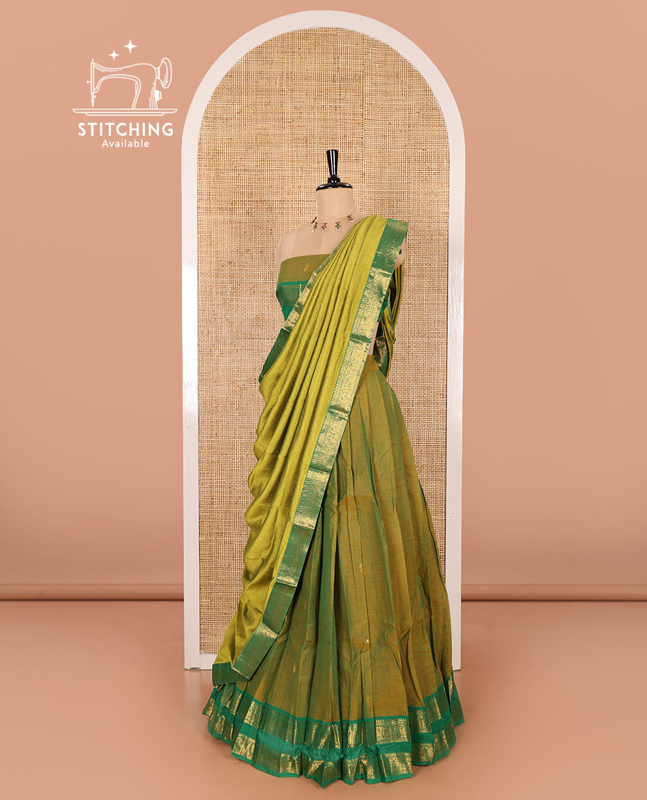 Mehendi Green and Green Chettinad Cotton Half-Saree Featuring Buttas Woven Skirt, Highlighted with a Contrast Rettai Pettu Peacock Motifs Woven Zari Border, a Subtly Woven Matching Blouse, and a Vichitra Silk Contrast Traditional Zari-Bordered Dhavani