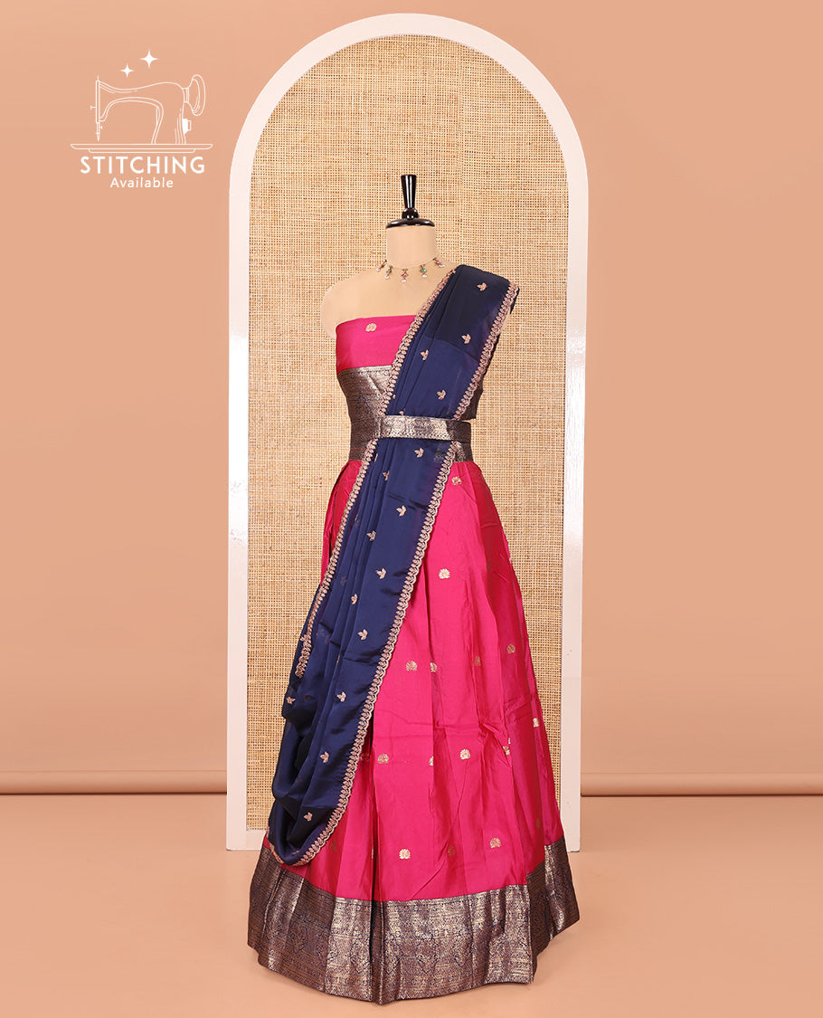 Pink and Navy Blue Semi-Banarasi Half-Saree, Adorned with Zari Buttas on Its Skirt, Complemented by a Contrast Traditional Zari Designs Woven Border, Paired with a Matching Blouse, and a Satin Georgette Embroidered Scallop Dhavani