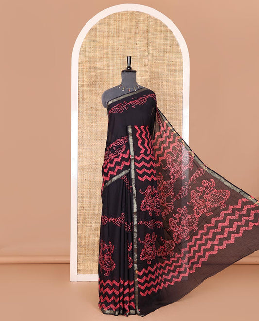 Ink blue wax batik-style zig-zag printed pure cotton saree, gold zari piping border, human figurines batik printed pallu, and a matching blouse