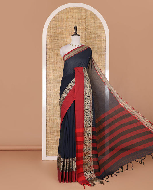 Navy blue plain mercerised cotton saree, contrast traditional border of peacock, and elephant motifs, striped pallu, and a matching blouse