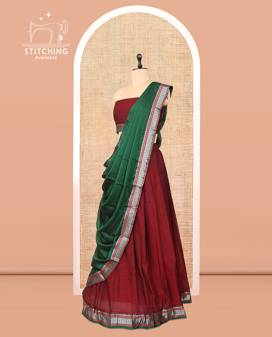 Maroon Cotton Half-Saree Features Plain Skirt, a Contrast Traditional Border, a Matching Blouse, and a Contrast Dhavani