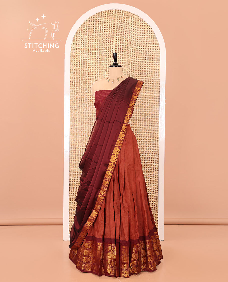Rust and Maroon Plain Sungudi Cotton Half-saree, Complemented by Captivating Contrast Traditional Zari Border of Temple, Peacock, and Elephant Designs, Paired with a Contrast Zari Checked Blouse, and Comes with a Zari-Bordered Vichitra Silk Dhavani