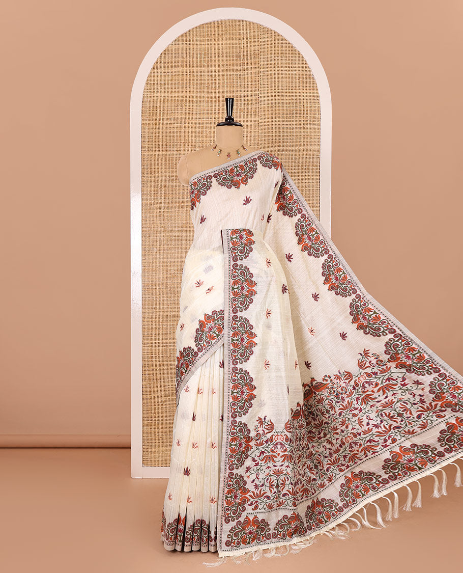 Half-white lotus motifs thread woven jute cotton, scallop thread woven border, pallu of lotus, peacock and paisley designs along with a plain blouse