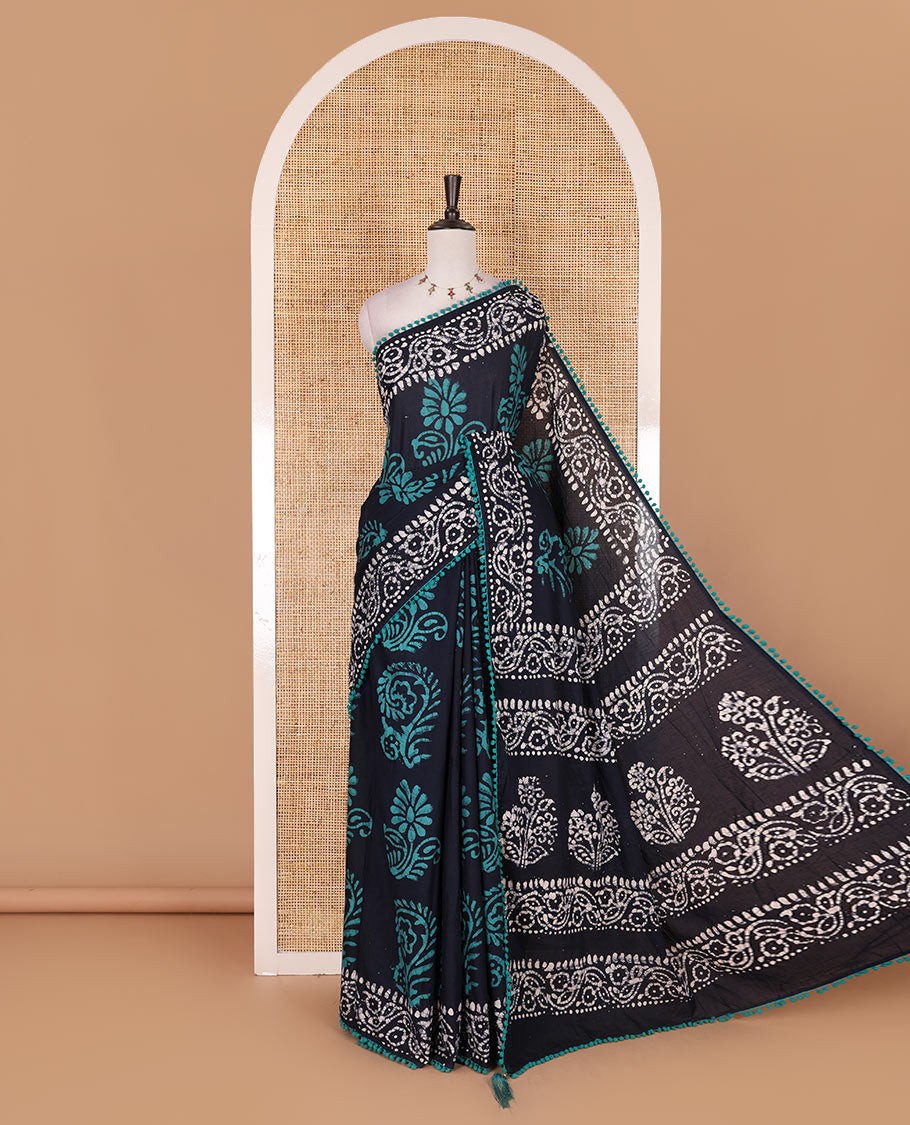 Navy blue-green batik floral printed soft cotton saree, batik printed pom-pom tasseled border, batik floral printed pallu, and a matching blouse