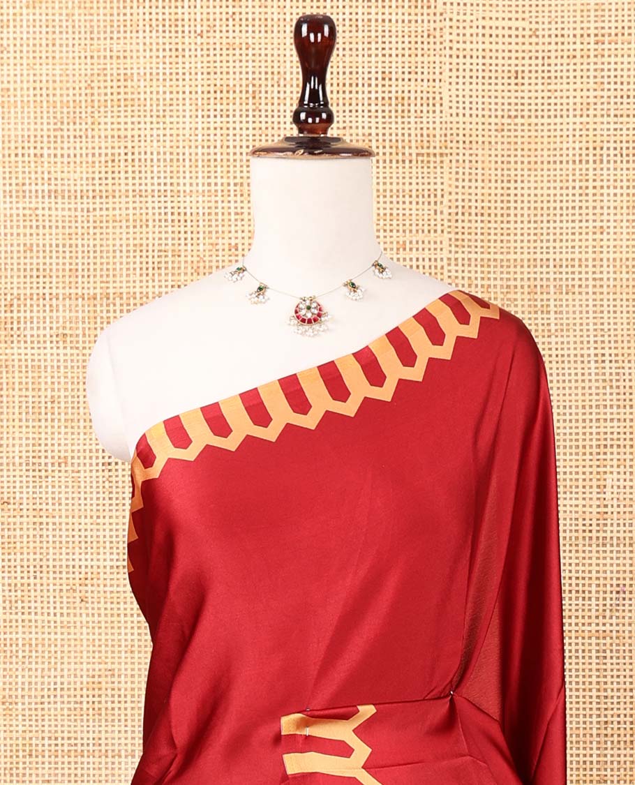 Maroon plain gajji silk saree features a temple-printed border, a circular-shaped vine-patterned pallu, and a unique motif-printed blouse
