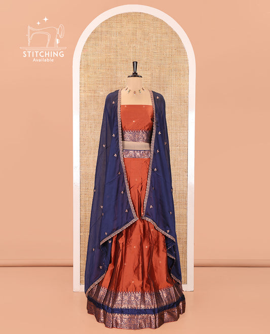 Rust and Blue Semi-Banarasi Half-Saree, Accentuated with Zari Buttas on Its Skirt, Complemented by a Contrast Rettai Pettu Traditional Zari-Design Border, Paired with a Matching Blouse, and Comes with a Contrast Satin Georgette Embroidered Dhavani