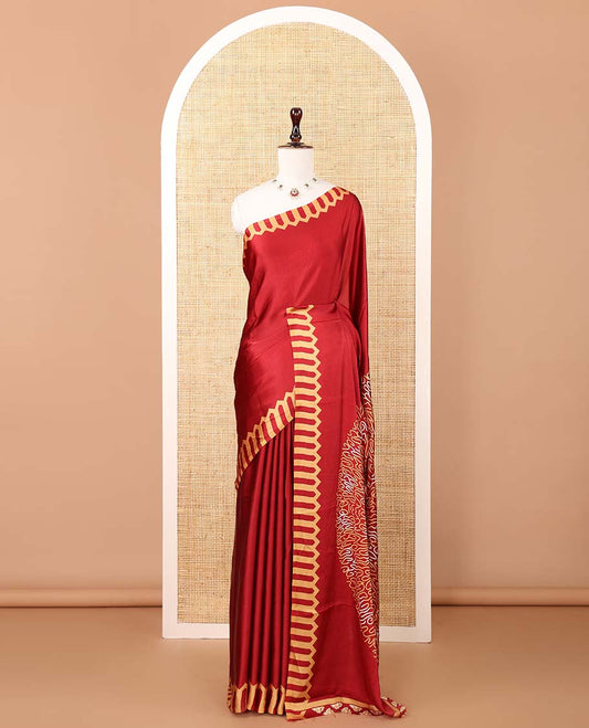 Maroon plain gajji silk saree features a temple-printed border, a circular-shaped vine-patterned pallu, and a unique motif-printed blouse