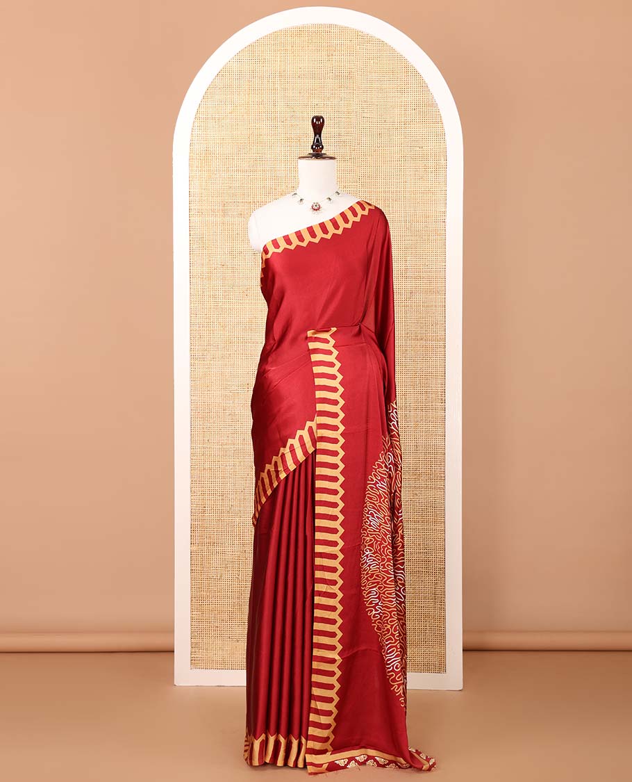 Maroon plain gajji silk saree features a temple-printed border, a circular-shaped vine-patterned pallu, and a unique motif-printed blouse