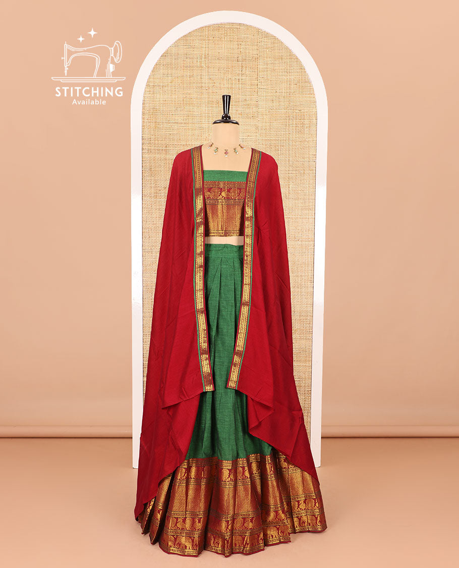 Green half-saree, plain with contrast traditional zari border skirt, matching zari bordered blouse, and contrast zari bordered dhavani