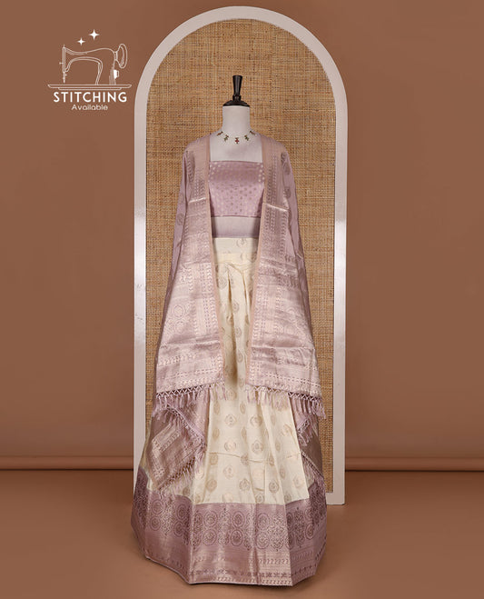 Cream and lavender semi-banarasi half-saree, zari buttas with contrast swarovski stone work border skirt, contrast zari buttas blouse, and intricate zari dhavani