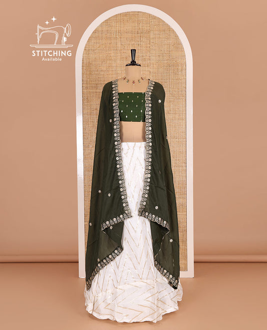 Cream-mehendi green half-saree, gold chevron striped nylon viscose crepe skirt, contrast diamond buttas blouse, and  a contrast scallop floral-theme embroidered dhavani