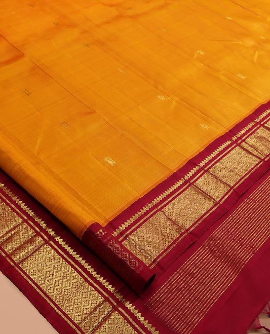 Orange Kanchipuram Silk Saree, Adorned with Zari Buttas, a Contrast Korvai One-Sided Border of Thilakam Mokku, Banaras, and Jaal Designs, Zari Design Pallu, and No Blouse