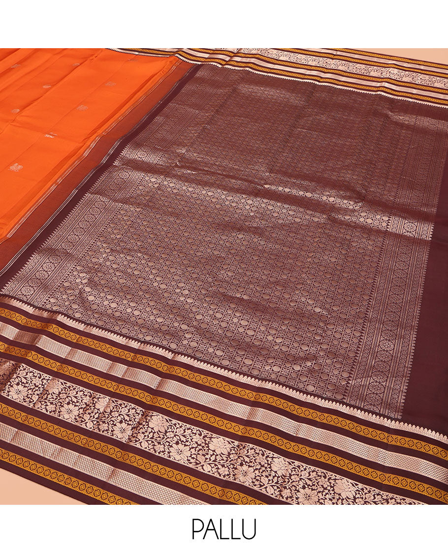 Orange Vasundhara Silk Saree, Adorned with Annam Chakram Buttas All Over Its Body, Complemented by Contrast Border of Thilakam, Neli, Laddu Kamalam, Mayil Kann, and Kodi Visiry Designs, Pallu of Butta Enclosed Checks, and Paired with a Contrast Blouse