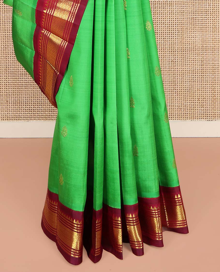 Green Kanchipuram Silk Saree, Embellished with Zari Buttas on Its Body, Complemented by a Contrast One-Sided Korvai Border of Rekku, Banaras, Muthu, and Mayil Kann Designs, Pallu Features Zari Designs, and Comes Without a Blouse