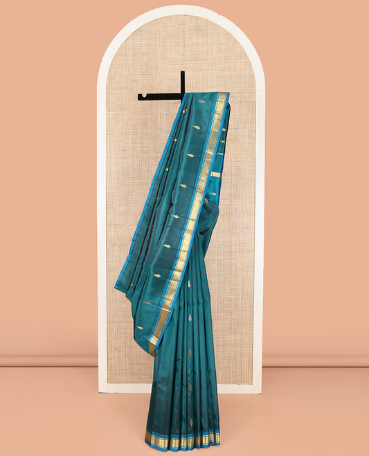 Blue Kanchipuram Silk Saree, Adorned with Zari Buttas on Its Body, Complemented by a Contrast One-Sided Border of Banaras, and Mayil Kann Designs, Pallu Steeped with Zari Designs, and Comes Without a Blouse