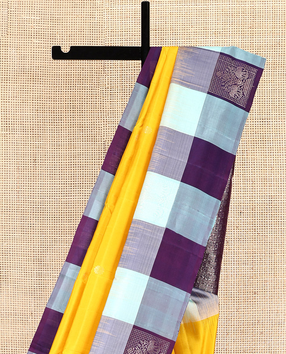 Yellow Kanchipuram Silk Saree, Sparsely Sparkled with Mayil-Chakram Buttas, Complemented by a Contrast Checked Yaanai Motif Border, Floral Pallu, and a Contrast Blouse