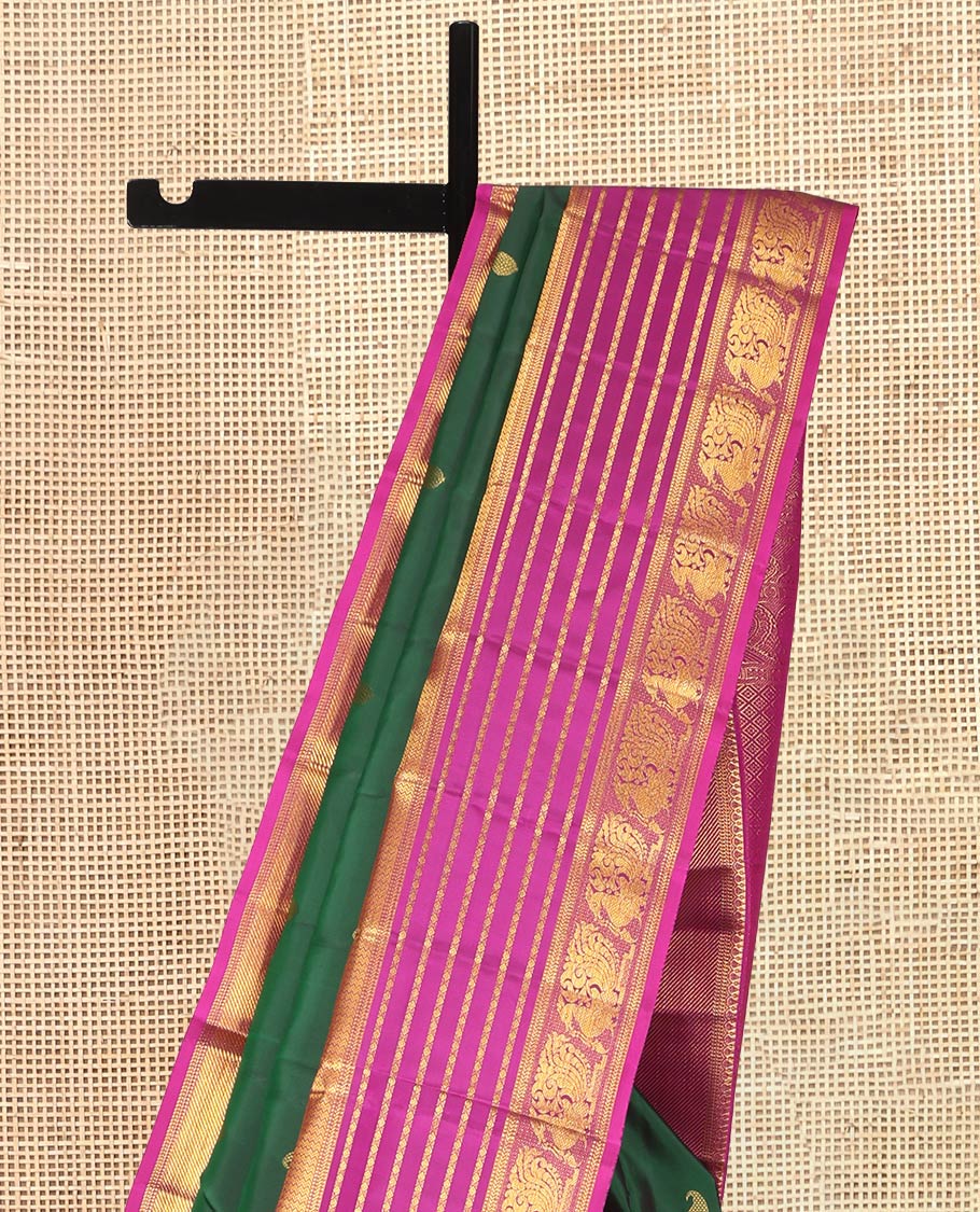 Green Kanchipuram Silk Saree, Adorned with Manga Buttas, a Contrast Korvai Border of Thilakam, Muthu, Vanki, Diamond, Kathir, and Mayil Designs, Jaal Pallu, and a Contrast Blouse