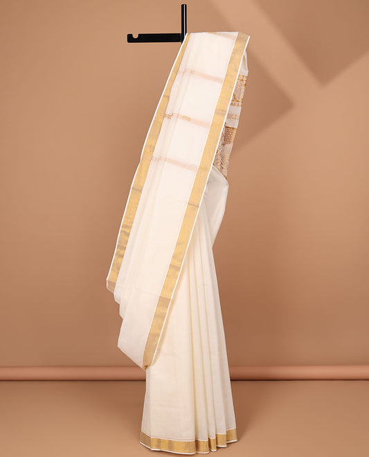 Cream kerala saree with zari stripes, zari border & pallu of traditional designs in zari
