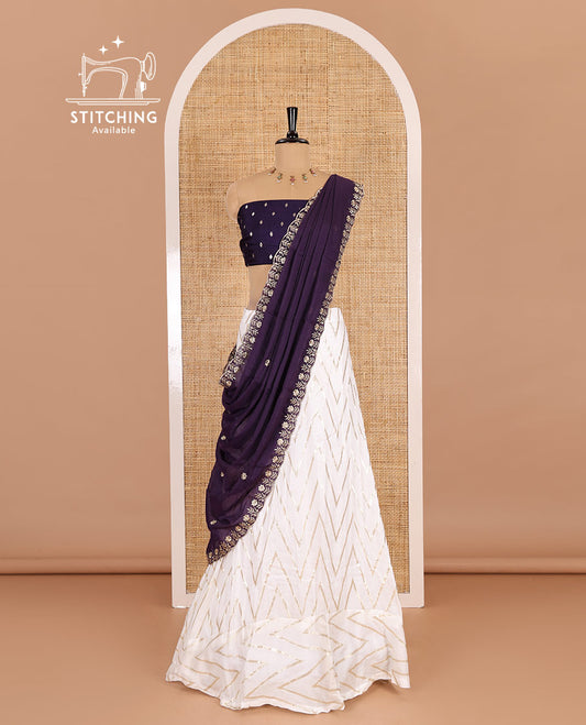 Cream-purple half-saree, gold chevron striped nylon viscose crepe skirt, contrast diamond buttas blouse, and  a contrast scallop floral-theme embroidered dhavani