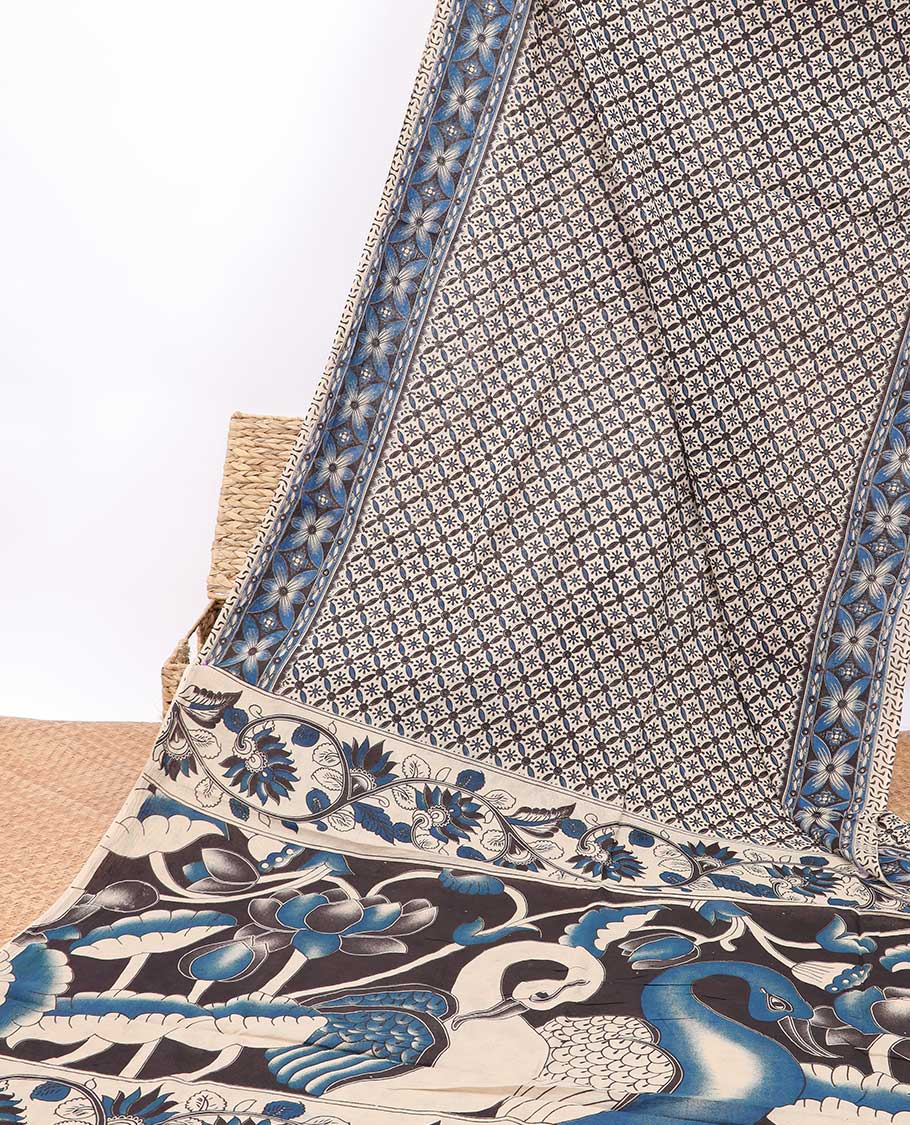 Cream floral enclosed checked design machine-printed kalamkari cotton saree with contrast floral border & peacock design pallu