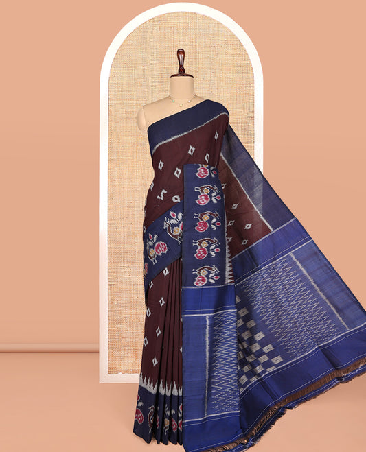 Brown Ikkat Cotton Saree, Decked Up with Ikkat Buttas All Over Its Body, Complemented by a Contrast Ikkat-Style Border of Peacock Buttas, Chevron Striped Pallu, and Paired with a Contrast Blouse