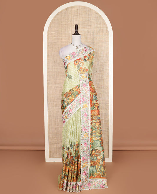 Pastel green buttas with bandhani and kalamkari floral-human motifs printed dola silk saree, contrast floral embroidered scallop border