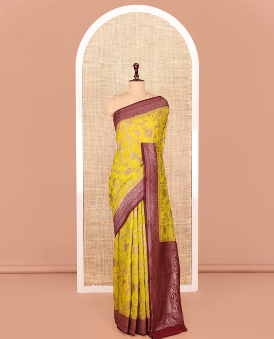 Yellow Georgette Saree, Artfully Detailed with Floral Jaal Jacquard Design on Its Body, Complemented by a Contrast Paisley Design Zari Woven Border, Pallu Depicts Mughal-Style Floral Zari Designs, and Paired with a Contrast Blouse