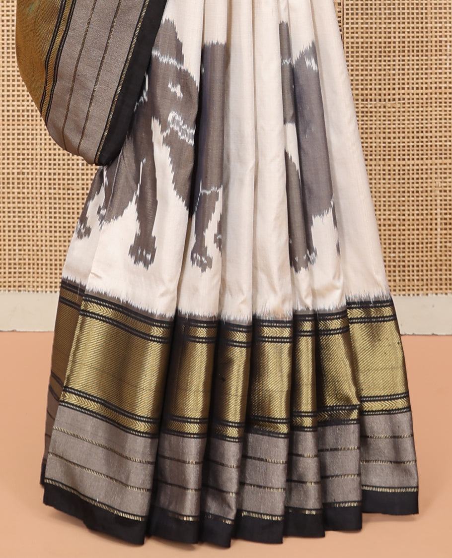 Cream Pochampally Ikat Saree, Adorned with Elephant Motifs, Complemented by a Contrast Traditional Zari Border, Ikat Pallu, and a Contrast Blouse