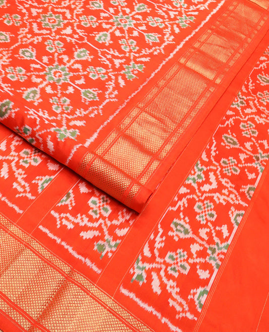 Orange Ikkat Silk Saree Hazily Woven in Ikkat Floral Design Across the Body, Featuring a Zari Border, Pallu of Ikkat Weave, and Paired with a Matching Blouse