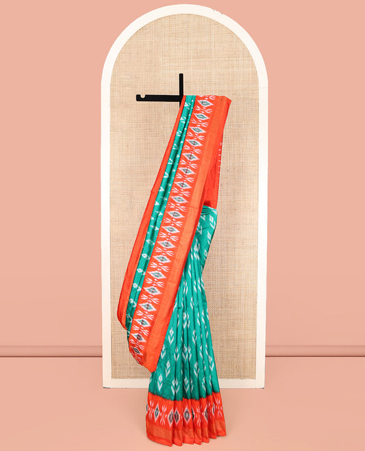 Green Ikkat Silk Saree, Accentuated with Ikkat Buttas All Over Its Body, Complemented by a Contrast Border of Ikkat Designs, Pallu of Butta Enclosed Jaal Designs, and Paired with a Contrast Blouse