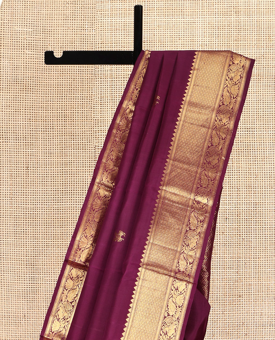 Maroon Kanchipuram Silk Saree, Accentuated with Kuthirai Buttas All Over Its Body, Highlighted by a Zari Border of Rekku, Muthu, Kathir, Mayil Kann, and Mayil Designs, Grand Jaal Pallu, and Paired with a Matching Blouse