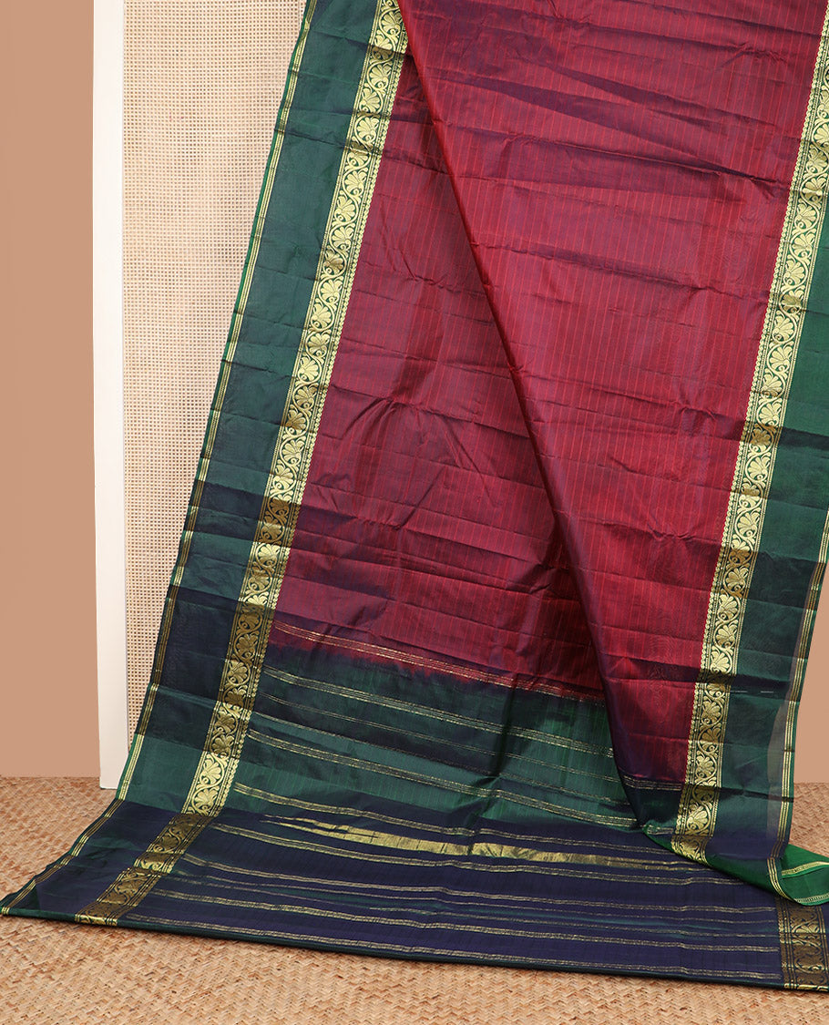 Maroon striped Kanchipuram silk saree, contrast rettai pettu border of manga, muthu, banaras, and kodi visiry designs, and zari striped pallu