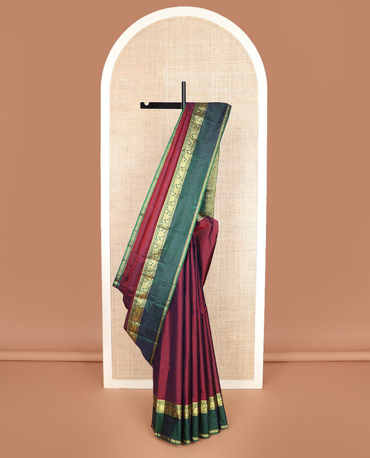 Maroon striped Kanchipuram silk saree, contrast rettai pettu border of manga, muthu, banaras, and kodi visiry designs, and zari striped pallu