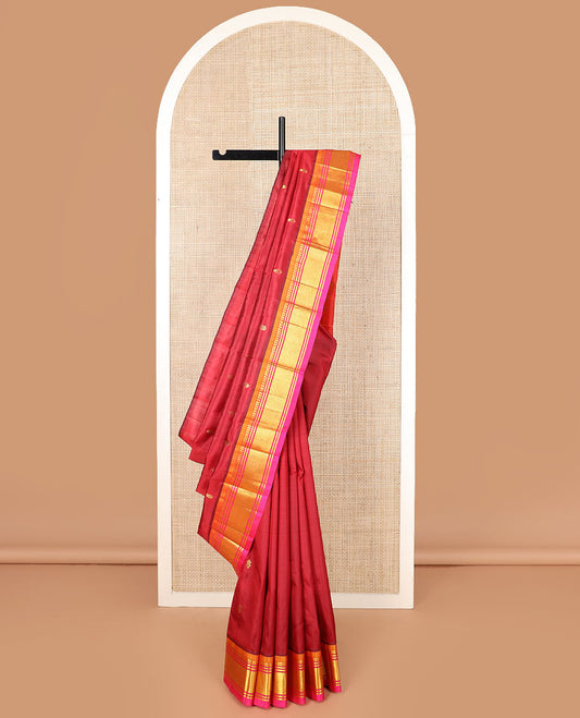 Maroon zari buttas Kanchipuram silk saree, contrast border of paneer sombu, banaras, and mayil kann designs, and zari design pallu