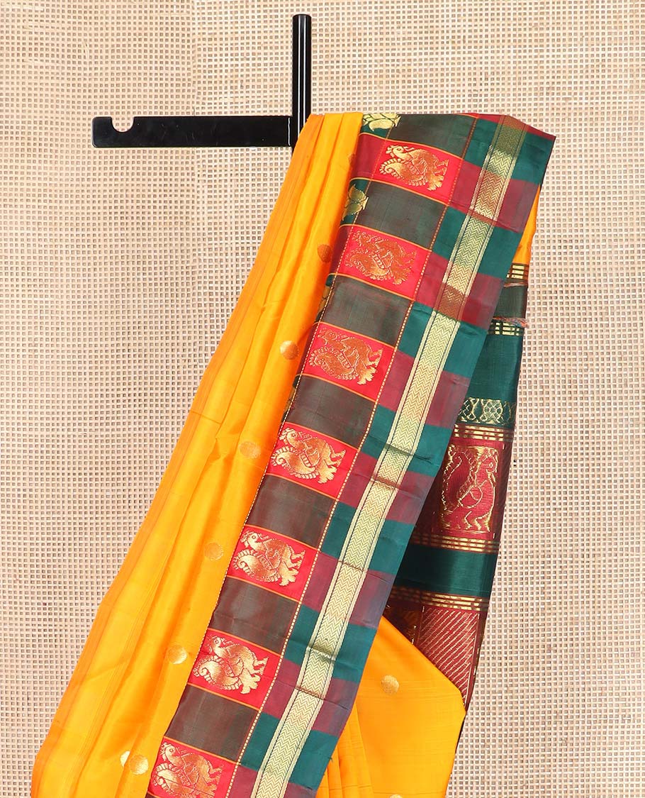 Yellow zari buttas Kanchipuram silk saree, contrast thazampoo rekku checked one-sided border of banaras, and vanki designs, and pallu of intricate designs