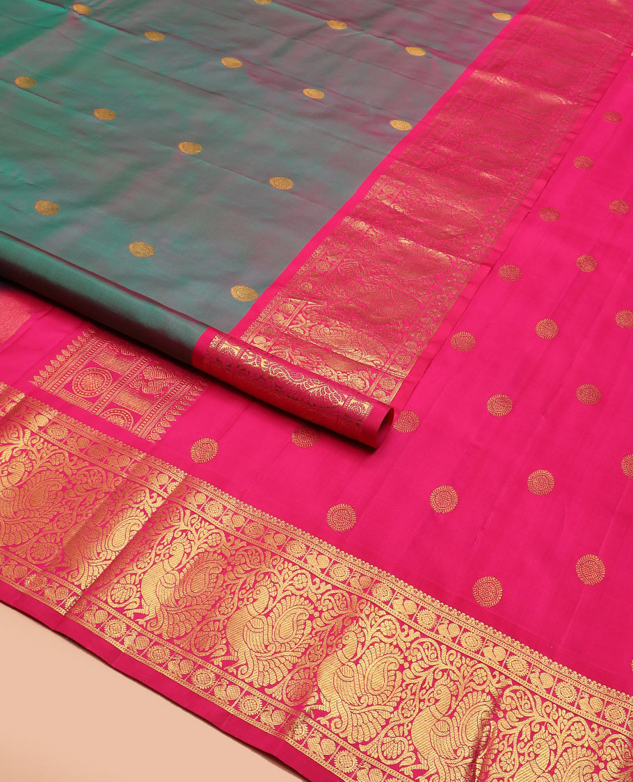 Green dual-tone chakram buttas Kanchipuram silk saree, contrast border of mayil chakram designs, and pallu of chakram buttas
