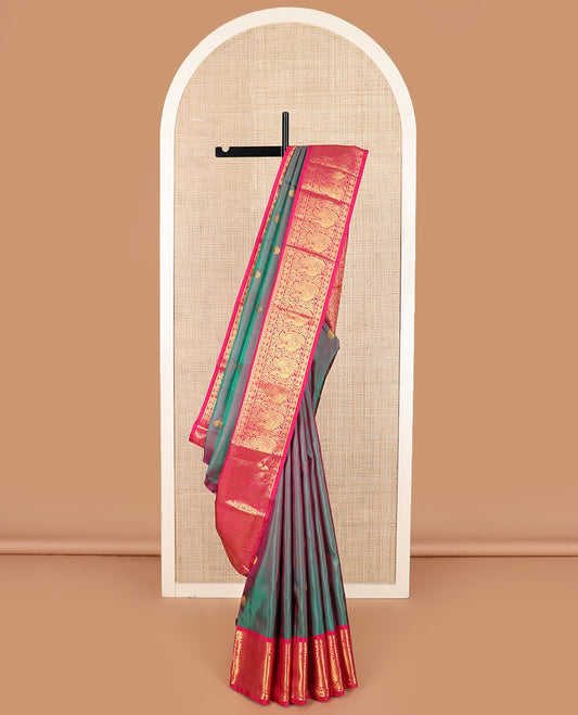 Green dual-tone chakram buttas Kanchipuram silk saree, contrast border of mayil chakram designs, and pallu of chakram buttas