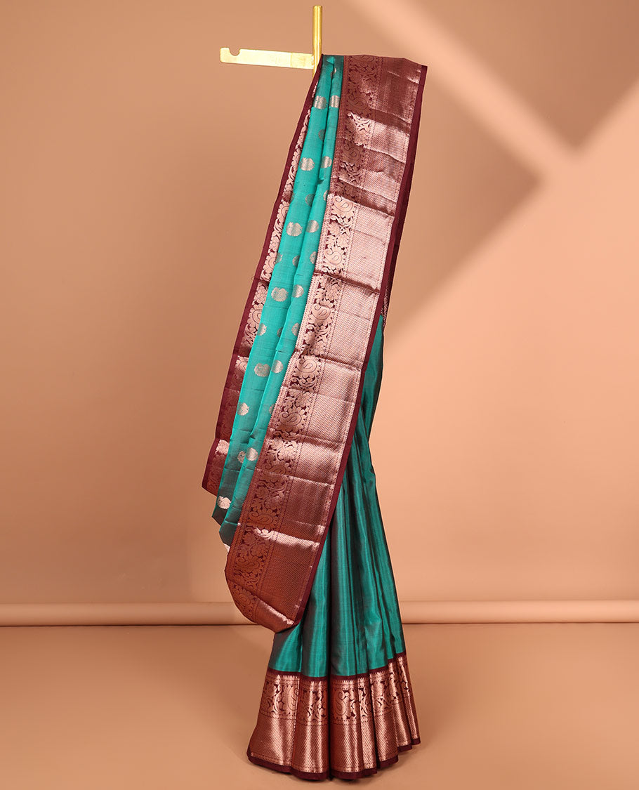 Green peacock buttas kancheepuram silk saree with contrast border of thilakam mokku, paun, mayil kann & zari design pallu