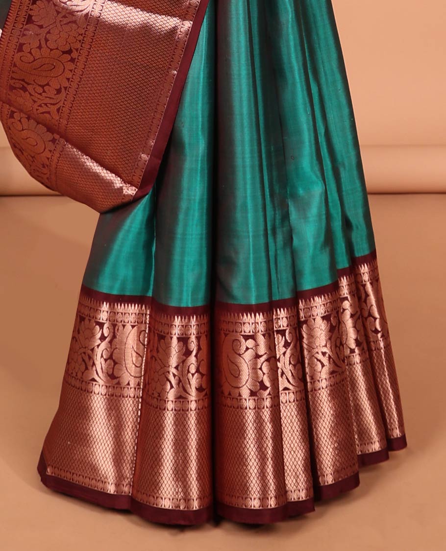 Green peacock buttas kancheepuram silk saree with contrast border of thilakam mokku, paun, mayil kann & zari design pallu