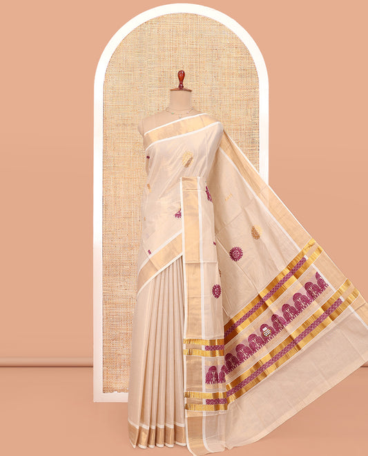 Cream Kerala Cotton Saree, Accentuated with Thread and Zari Buttas All Over Its Body, a Zari Bavanji Border, Pallu of Elephant Designs, and Paired with a Matching Blouse