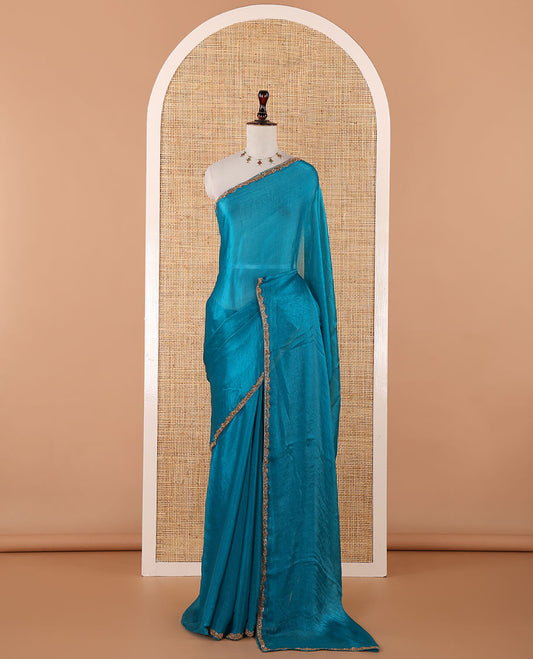 Rama blue fendy chiffon saree with hand work border & self pallu along with hand work blouse