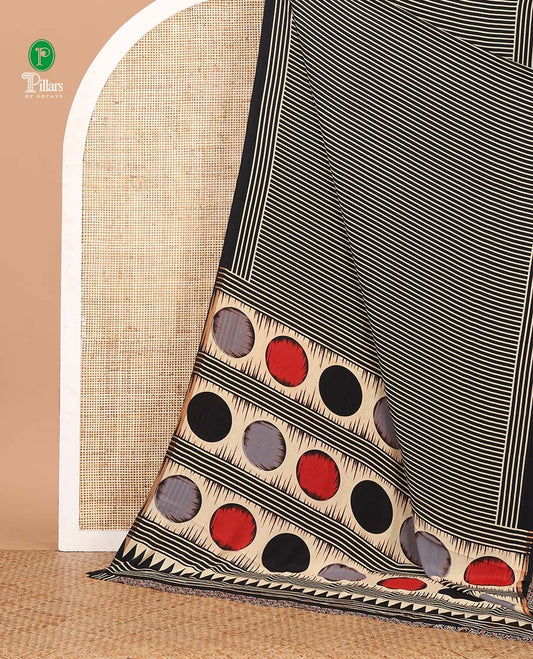 Black vertical stripes printed modal satin saree, a self-border of horizontal stripes print, polka dots printed on the pallu, and an intricate ajrakh-style printed blouse