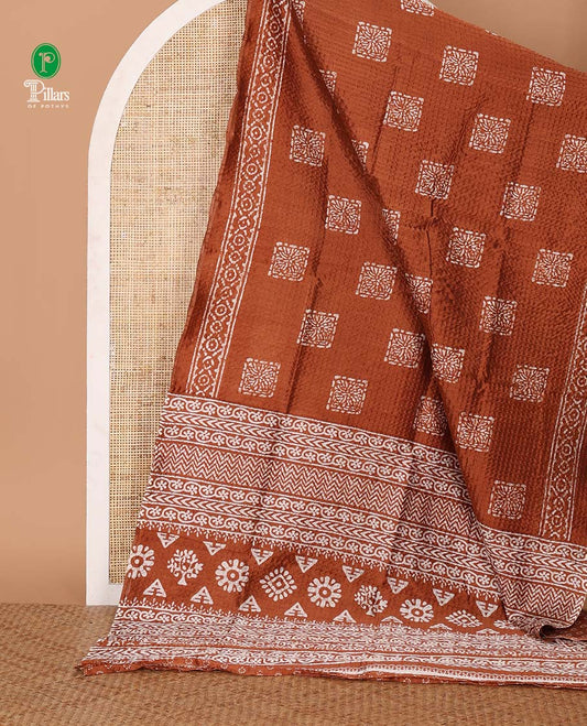 Rust batik-printed square motifs Litchi crushed saree, batik-printed border & pallu of geometric & floral batik print