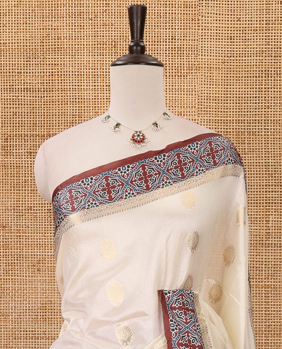 Cream gold zari buttas semi-organza saree, contrast zari & Ajrakh printed brown border, zari weaving pallu & Ajrakh printed blouse