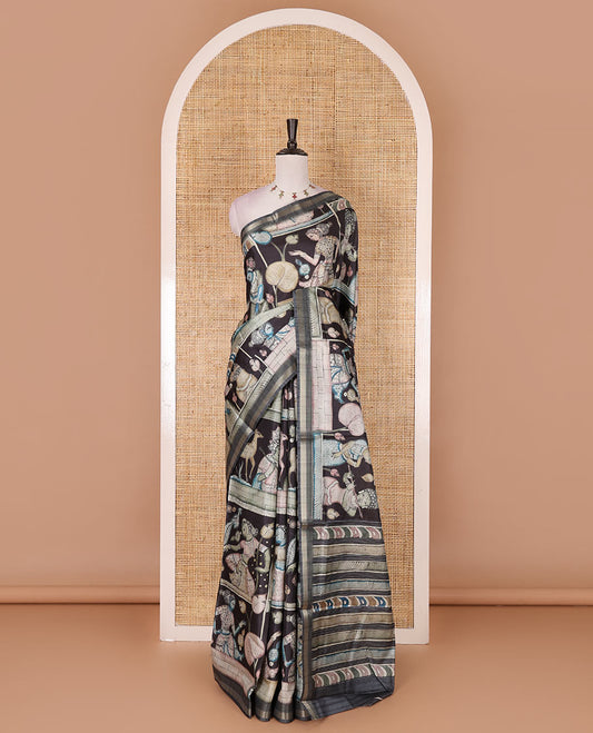 Black kalamkari ancient human figurines and animal motifs printed semi-tussar saree, gold zari piping border, printed pallu, and contrast printed blouse