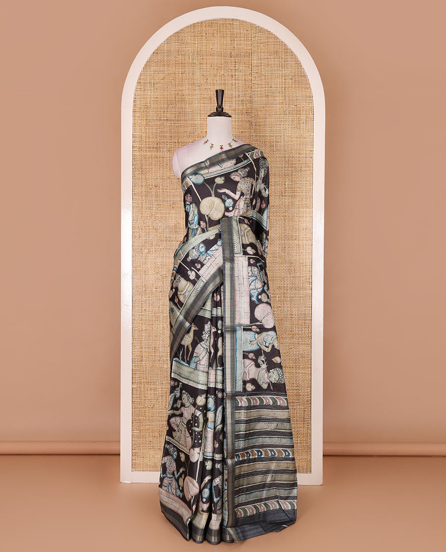 Black kalamkari ancient human figurines and animal motifs printed semi-tussar saree, gold zari piping border, printed pallu, and contrast printed blouse