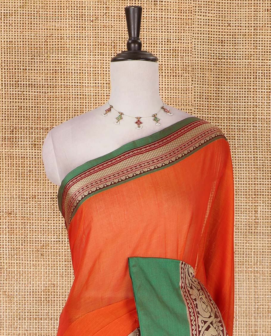 Orange plain mercerised cotton saree, contrast traditional border of peacock, and elephant motifs, striped pallu, and a matching blouse